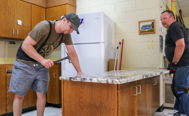 2 men installing kitchen counters