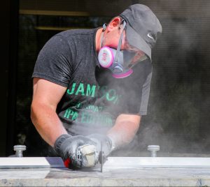 man saws through countertop