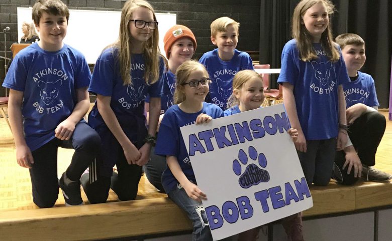 8 students with team sign