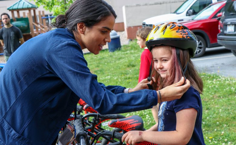 adult adjusting childs bike helmet