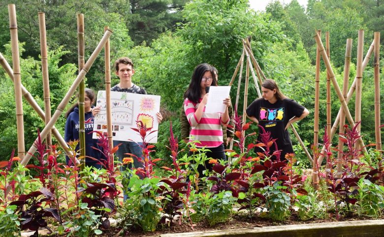 Four students presenting in their garden