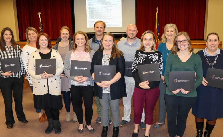 12 teachers holding certificates