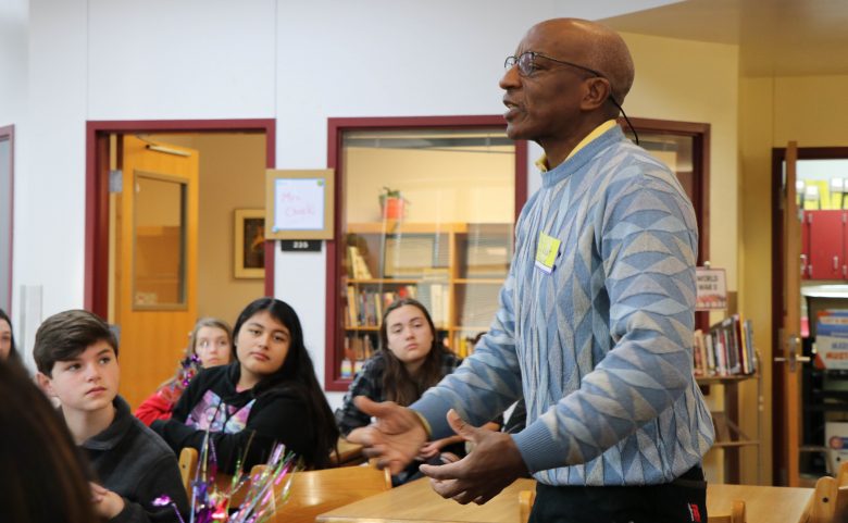 guest speaker talking to group of 4 students