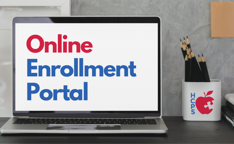 computer screen on desk with "Online Enrollment Portal" on screen