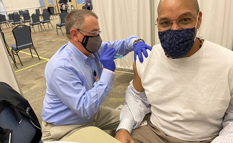 man getting COVID-19 vaccine