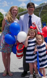 man, woman, and two daughters
