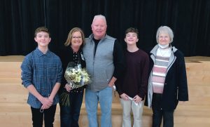 5 people standing indoors