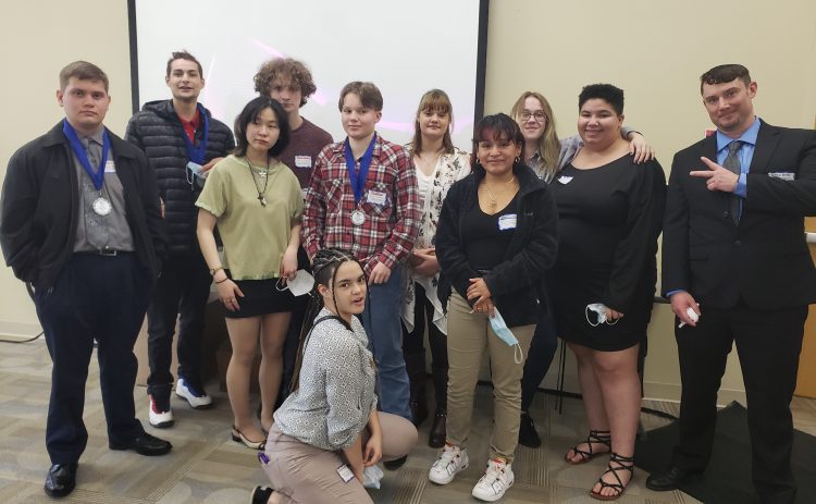 group photo of 11 people inside