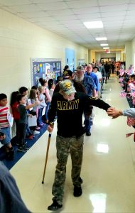 Parade of students and teachers honoring visiting veterans