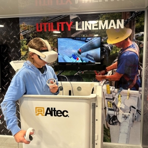 A student wearing a Virtual Reality headset at the lineman station in the Be Pro Be Proud truck. 