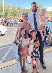 A family photo of Dr. McDaris, his wife, and three daughters. 