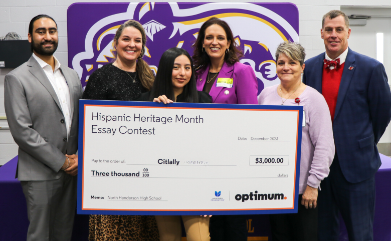 The optimum representative, Citlally, house reperesentative, two North Henderson employees, and the HCPS Superintendent Mark R. Garrett pose for a photo with a large check.