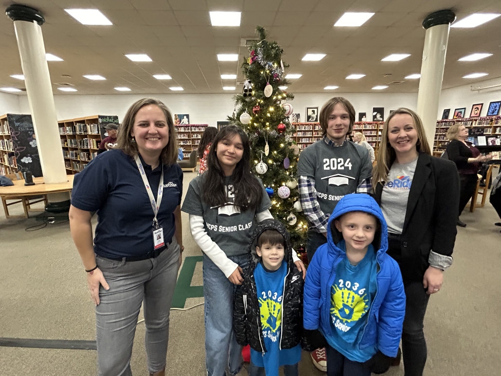 Two blue ridge sponsors posing for a photo with two kindergarteners and two seniors. 