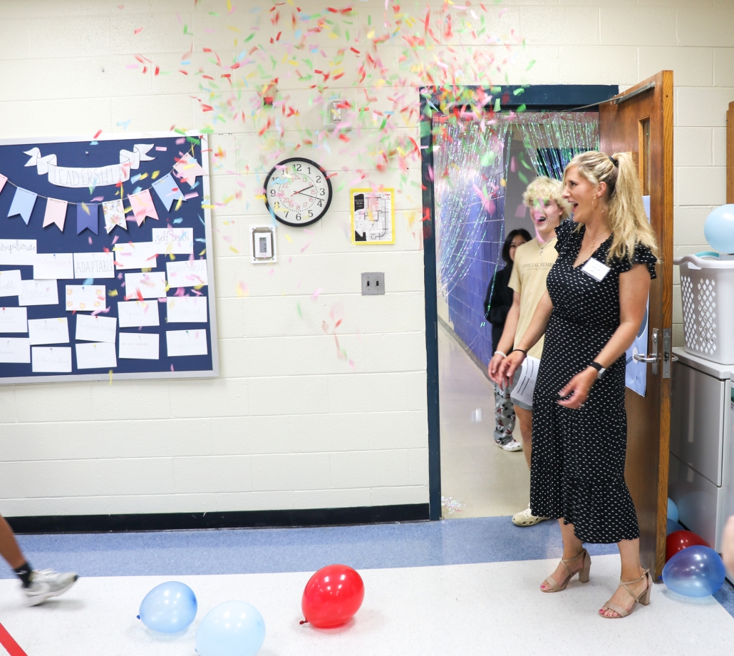 Confetti catches Kelly Stepp by surprise as she walks into her classroom.