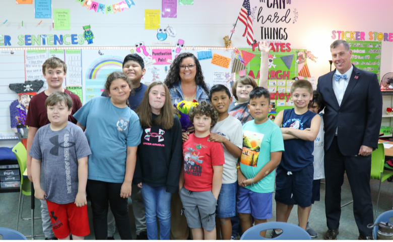 A class photo of Ms. Torey Owens, Superintendent Mark Garrett and 10 students.